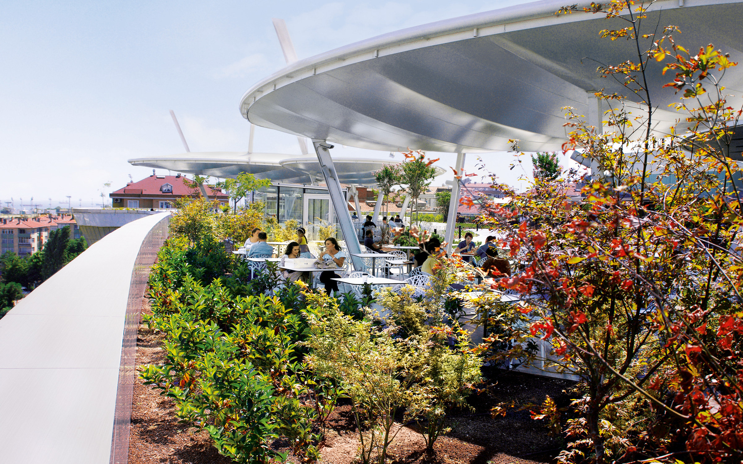 The green roof provides a natural atmosphere for the city residents. People sitting in a cafè on a roof garden